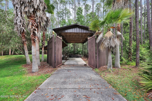 view of home's community featuring a lawn, driveway, and a detached carport
