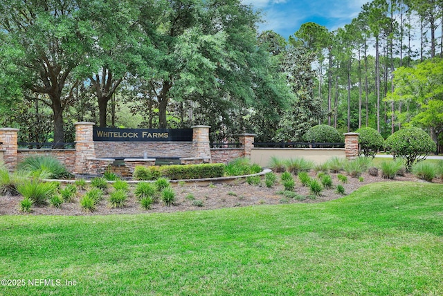 community / neighborhood sign with a lawn