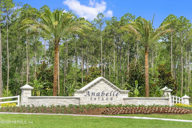 community sign featuring fence
