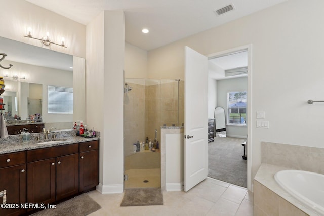bathroom featuring tile patterned flooring, visible vents, vanity, a garden tub, and a stall shower