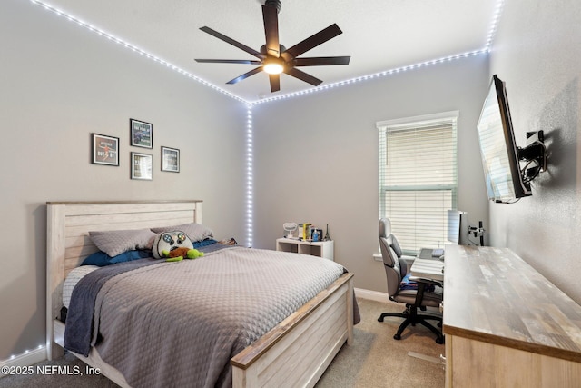 bedroom with baseboards, a ceiling fan, and light colored carpet