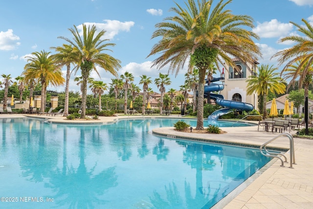 pool featuring a patio area and a water slide