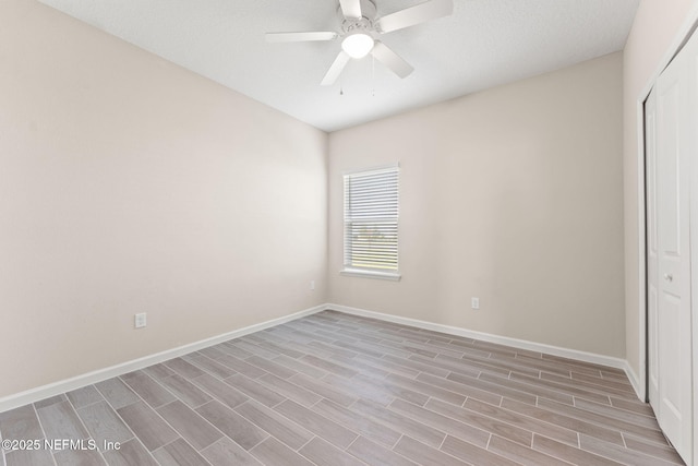 unfurnished bedroom with baseboards, a ceiling fan, light wood finished floors, and a closet