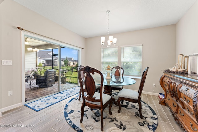 dining room featuring wood finish floors, a chandelier, and a healthy amount of sunlight