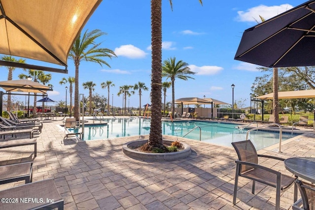 pool featuring a patio and fence