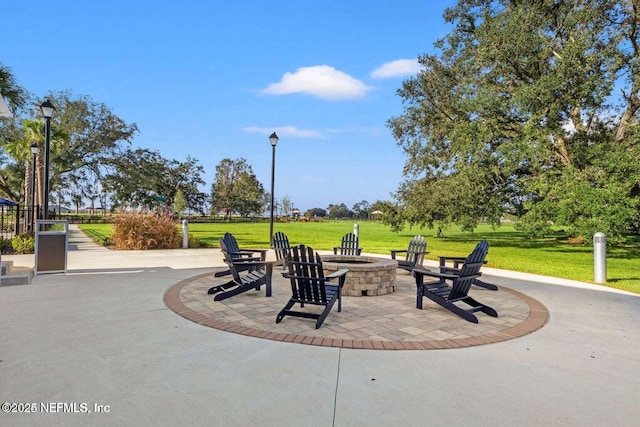 surrounding community featuring a patio area, a yard, and an outdoor fire pit