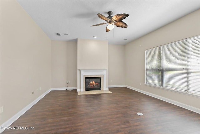 1124 Westfield Way, Saint Augustine, FL 32095 - unfurnished living room featuring baseboards, a ceiling fan, a wealth of natural light, and a fireplace with flush hearth