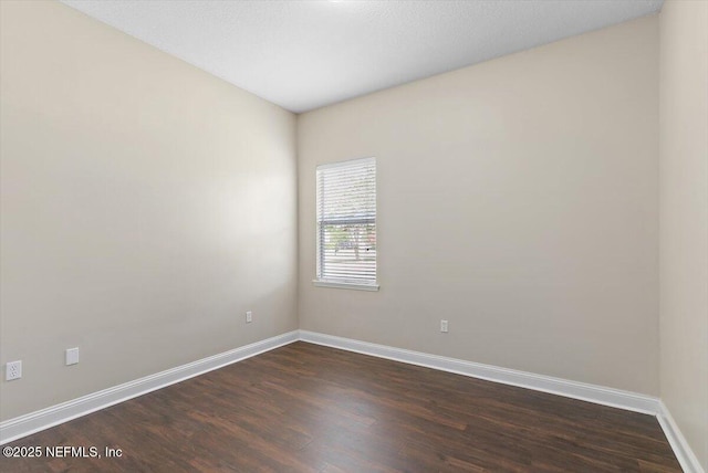 1124 Westfield Way, Saint Augustine, FL 32095 - empty room with dark wood finished floors and baseboards