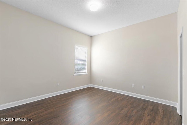 1124 Westfield Way, Saint Augustine, FL 32095 - spare room with dark wood-style flooring and baseboards