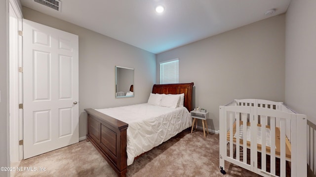 carpeted bedroom with visible vents and baseboards