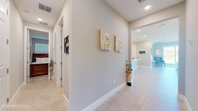 hallway with visible vents, recessed lighting, and light tile patterned flooring