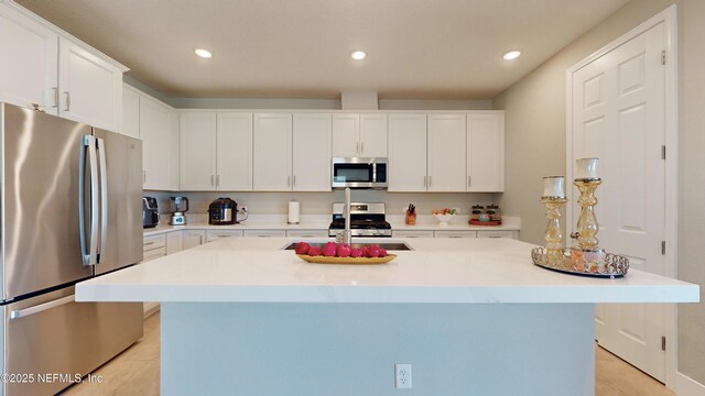 kitchen with white cabinets, recessed lighting, appliances with stainless steel finishes, and light tile patterned floors