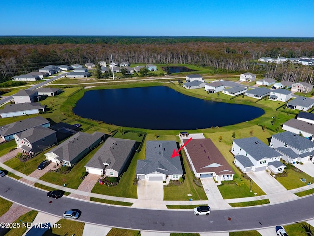 bird's eye view with a forest view, a water view, and a residential view
