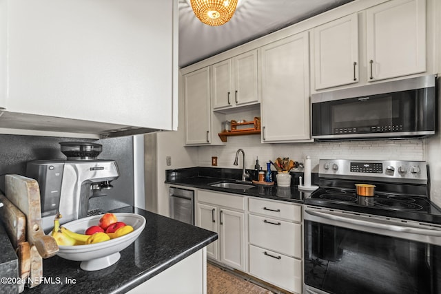 kitchen featuring dark stone counters, a sink, open shelves, backsplash, and appliances with stainless steel finishes