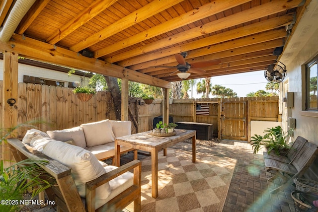 view of patio featuring a gate, an outdoor living space, and a fenced backyard
