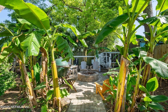 view of patio / terrace featuring a fire pit and fence