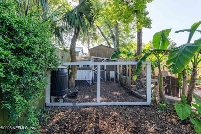 view of yard with fence private yard, exterior structure, and an outbuilding