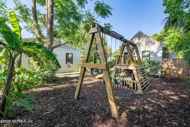 view of playground featuring fence