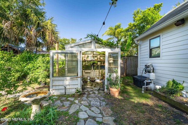 view of greenhouse with fence