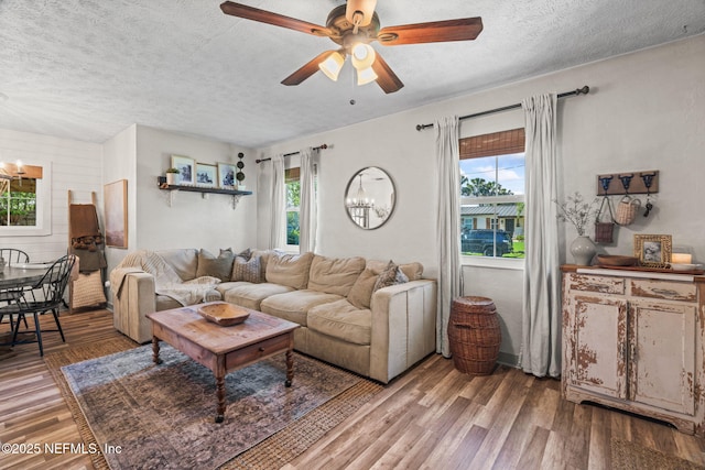 living area featuring a textured ceiling, a healthy amount of sunlight, and wood finished floors