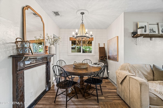 dining space with a chandelier, visible vents, dark wood-type flooring, and plenty of natural light