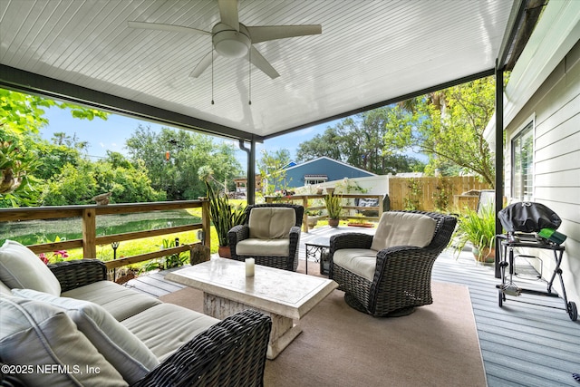 deck with fence, a ceiling fan, and an outdoor living space