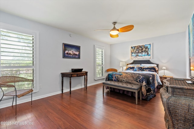 bedroom featuring a ceiling fan, wood finished floors, and baseboards