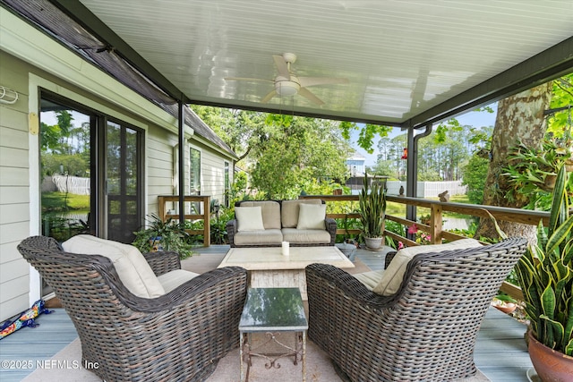 exterior space with ceiling fan, outdoor lounge area, and plenty of natural light