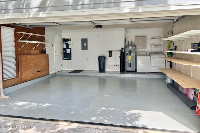 garage with electric panel, water heater, and independent washer and dryer