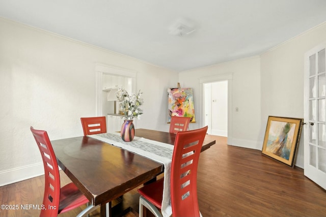 2234 Forbes St, Jacksonville, FL 32204 - dining room featuring wood finished floors, crown molding, and baseboards