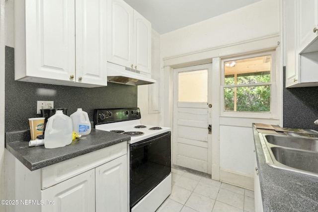 2234 Forbes St, Jacksonville, FL 32204 - kitchen with white cabinets, white electric stove, under cabinet range hood, and a sink