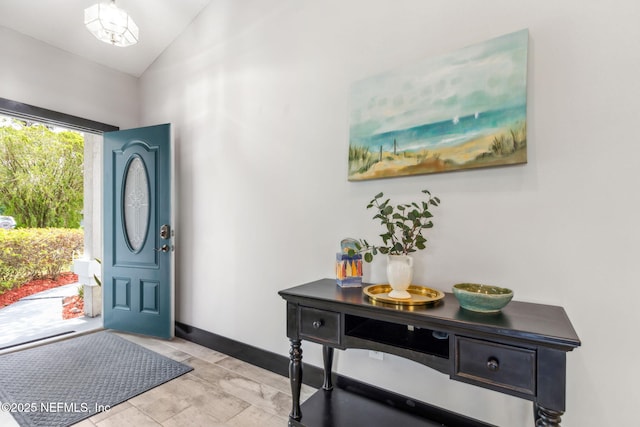 foyer featuring vaulted ceiling