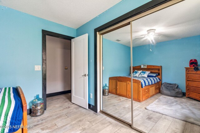 bedroom featuring wood finished floors, a ceiling fan, and visible vents