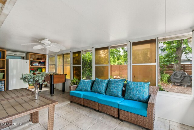 sunroom featuring an outdoor living space, ceiling fan, and plenty of natural light