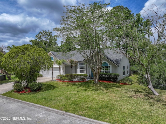 single story home featuring concrete driveway, roof with shingles, a front yard, stucco siding, and a garage