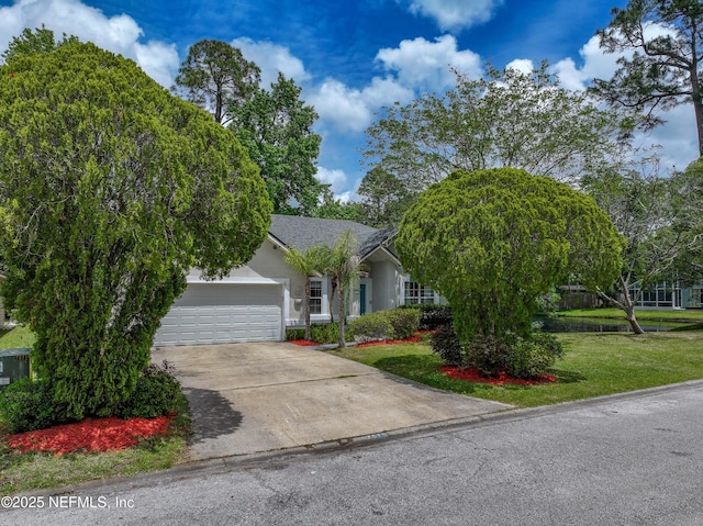 view of front facade featuring an attached garage, concrete driveway, a front yard, and stucco siding