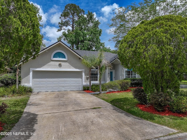 ranch-style home featuring a garage, stucco siding, and driveway