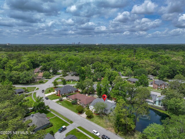 aerial view featuring a residential view and a wooded view