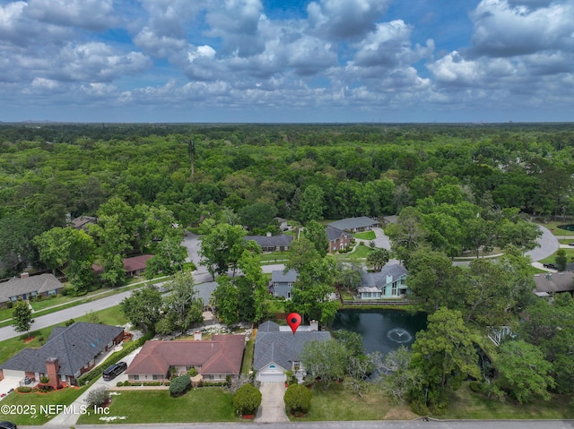 drone / aerial view featuring a residential view and a forest view