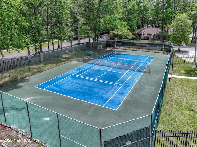 view of sport court featuring fence