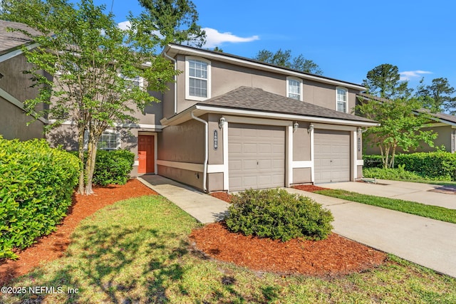 1605 Vineland Cir Unit B, Fleming Island, FL 32003 - traditional-style home featuring a garage, concrete driveway, and stucco siding