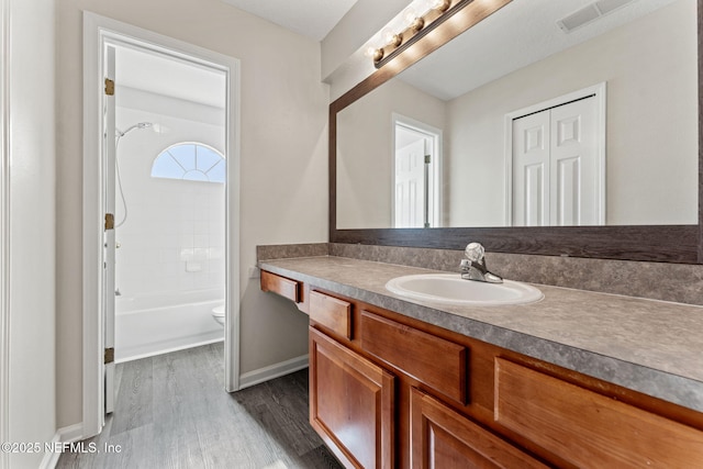 1605 Vineland Cir Unit B, Fleming Island, FL 32003 - full bath with toilet, baseboards, visible vents, wood finished floors, and vanity