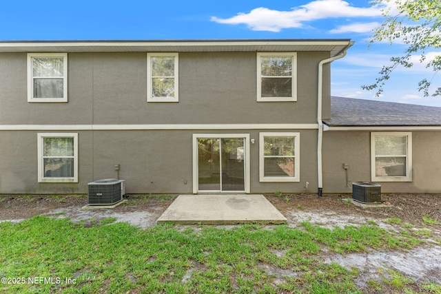 1605 Vineland Cir Unit B, Fleming Island, FL 32003 - rear view of property featuring a patio area, roof with shingles, central AC, and stucco siding