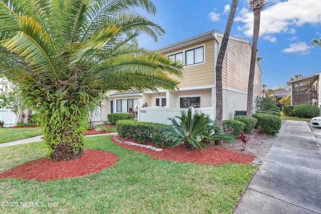 7908 Los Robles Ct Unit 7908, Jacksonville, FL 32256 - view of front of house featuring fence private yard, stucco siding, and a front yard