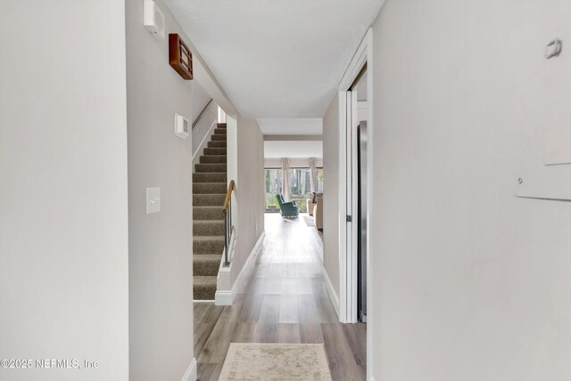 7908 Los Robles Ct Unit 7908, Jacksonville, FL 32256 - corridor featuring baseboards, light wood-type flooring, and stairway