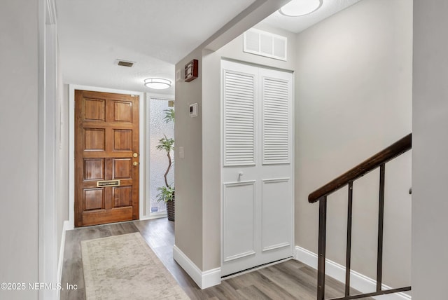 7908 Los Robles Ct Unit 7908, Jacksonville, FL 32256 - foyer with wood finished floors, visible vents, stairway, and baseboards