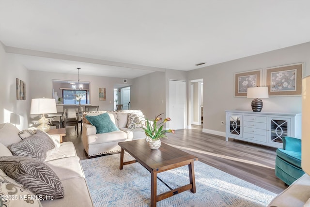 7908 Los Robles Ct Unit 7908, Jacksonville, FL 32256 - living area featuring baseboards, visible vents, wood finished floors, and a notable chandelier