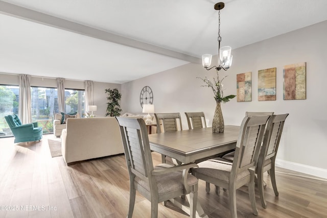 7908 Los Robles Ct Unit 7908, Jacksonville, FL 32256 - dining space with a chandelier, light wood-style flooring, and baseboards