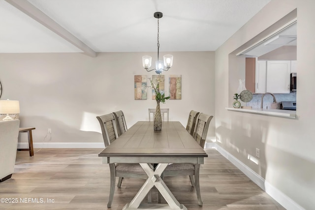 7908 Los Robles Ct Unit 7908, Jacksonville, FL 32256 - dining area featuring light wood finished floors, a chandelier, and baseboards