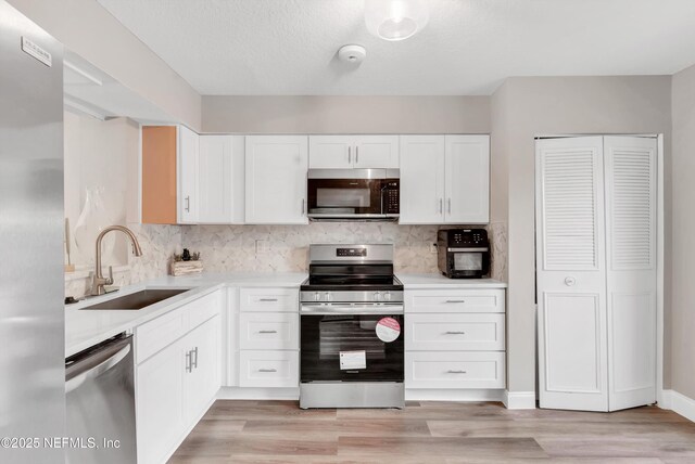 7908 Los Robles Ct Unit 7908, Jacksonville, FL 32256 - kitchen featuring decorative backsplash, stainless steel appliances, light countertops, and a sink